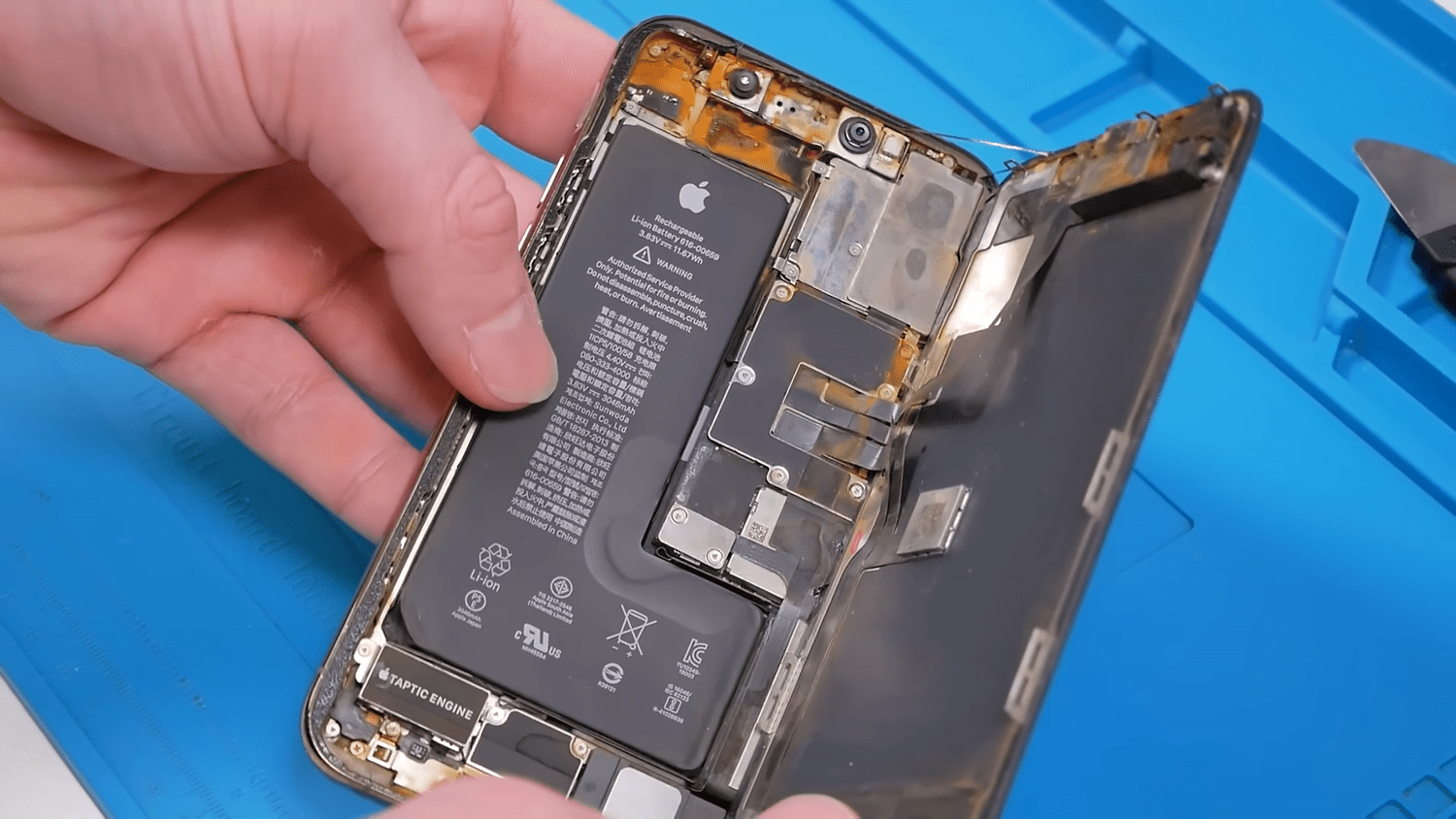 An iPhone open on the repair workbench